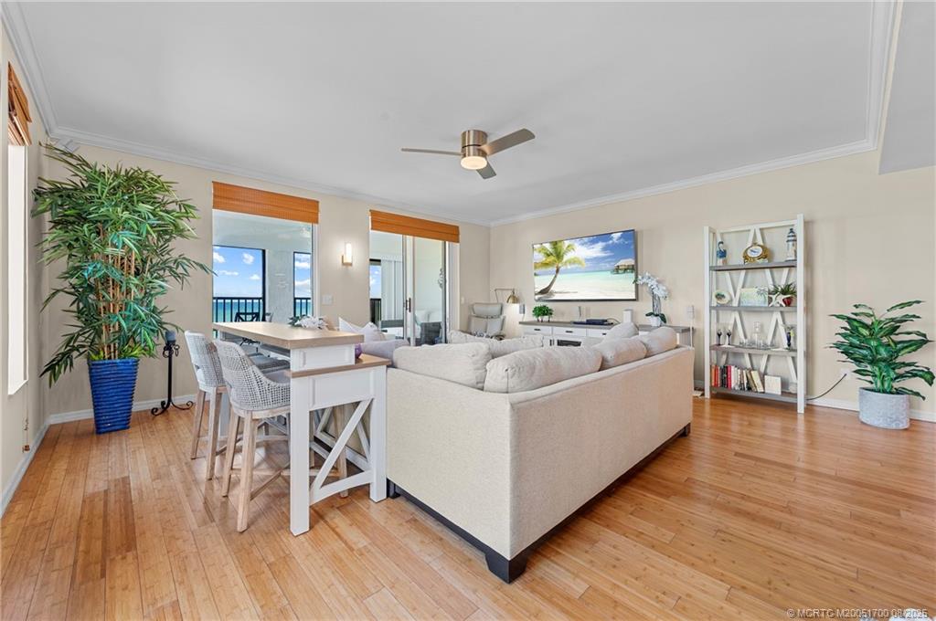 4651 Northeast Ocean Boulevard, Unit B26 Stuart, FL 34996 - Photo 10 of 35 a living room with furniture and a wooden floor
