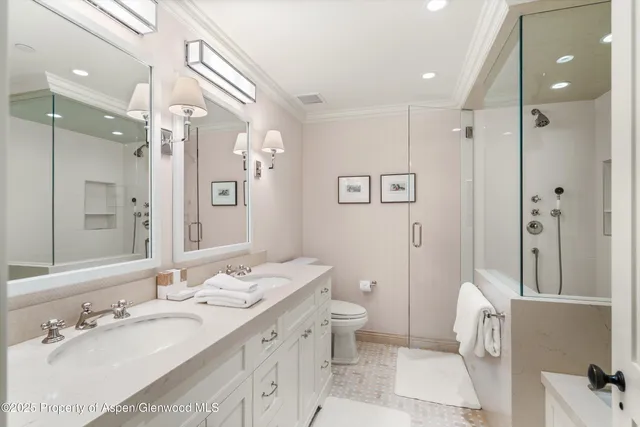 a spacious bathroom with a double vanity sink mirror and toilet