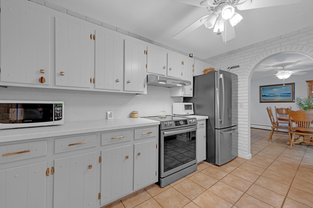 47 Horseshoe Circle Ware, MA 01082 - Photo 11 of 37 a kitchen with stainless steel appliances a stove refrigerator sink and cabinets