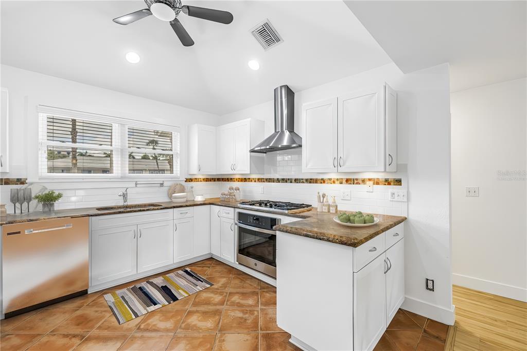 2605 Pass A Grille Way St. Pete Beach, FL 33706 - Photo 11 of 41 a kitchen with a stove and a sink