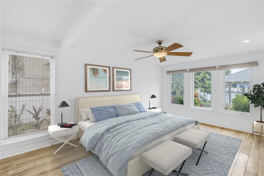 2605 Pass A Grille Way St. Pete Beach, FL 33706 - Photo 12 of 41 a bedroom with a large bed and a window