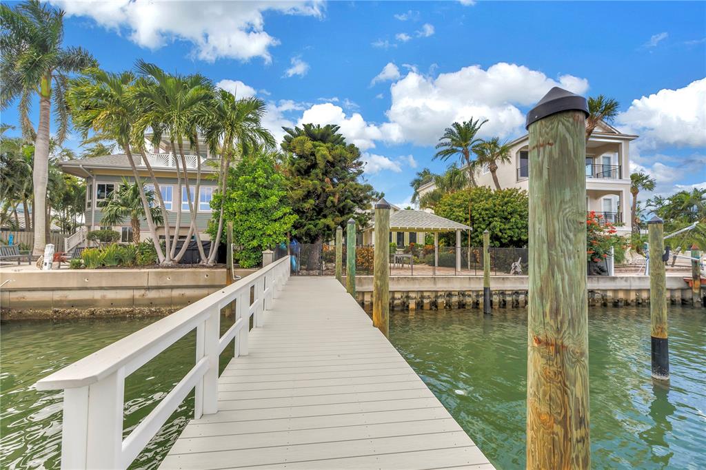 2605 Pass A Grille Way St. Pete Beach, FL 33706 - Photo 33 of 41 a lake view with a sitting space and large trees