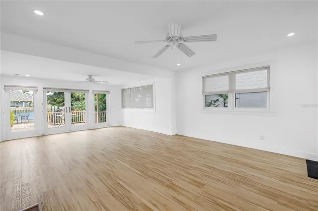 a view of empty room with wooden floor and fireplace