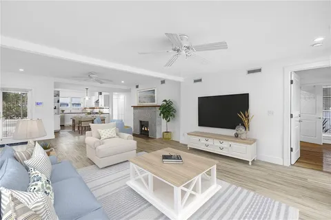 a view of empty room with wooden floor and fireplace