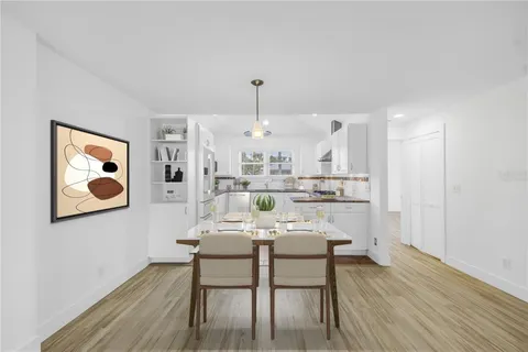 a living room with kitchen island furniture and wooden floor