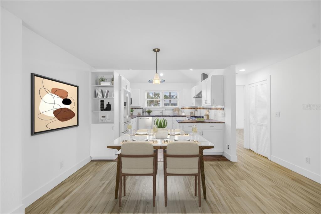 2605 Pass A Grille Way St. Pete Beach, FL 33706 - Photo 8 of 41 a view of a dining room with furniture and wooden floor