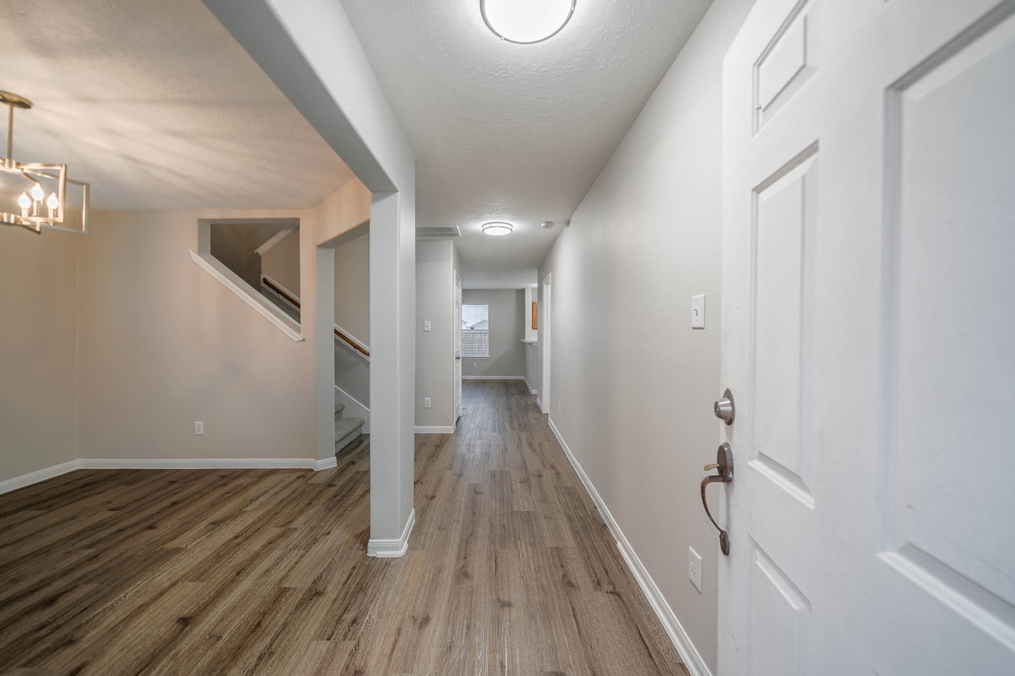 121 Rodeo Drive Manvel, TX 77578 - Photo 2 of 22 a view of a hallway with wooden floor and staircase