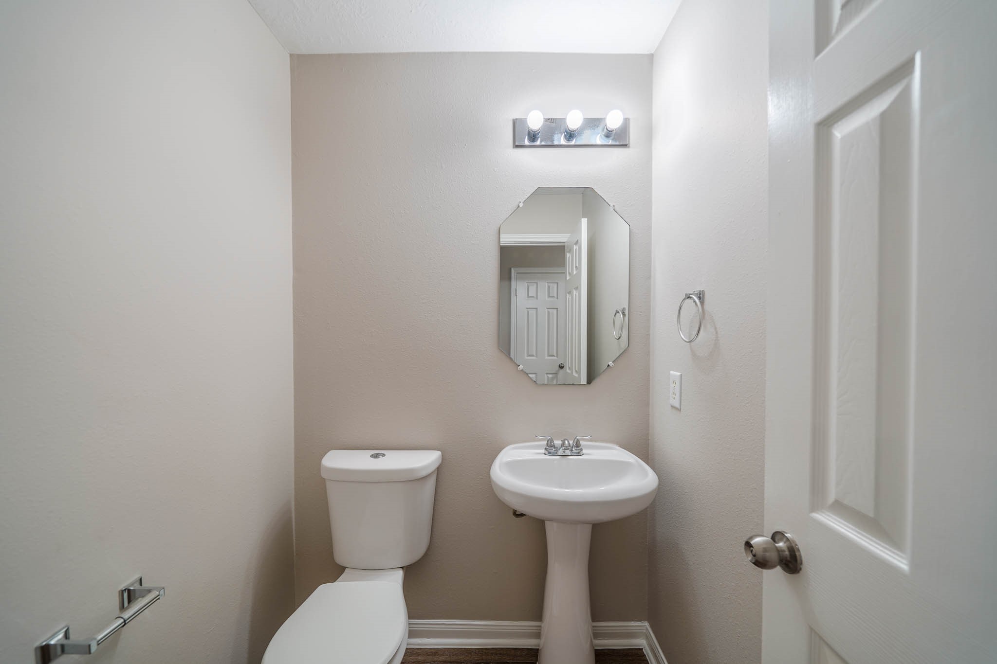 121 Rodeo Drive Manvel, TX 77578 - Photo 5 of 22 a bathroom with a toilet sink and mirror
