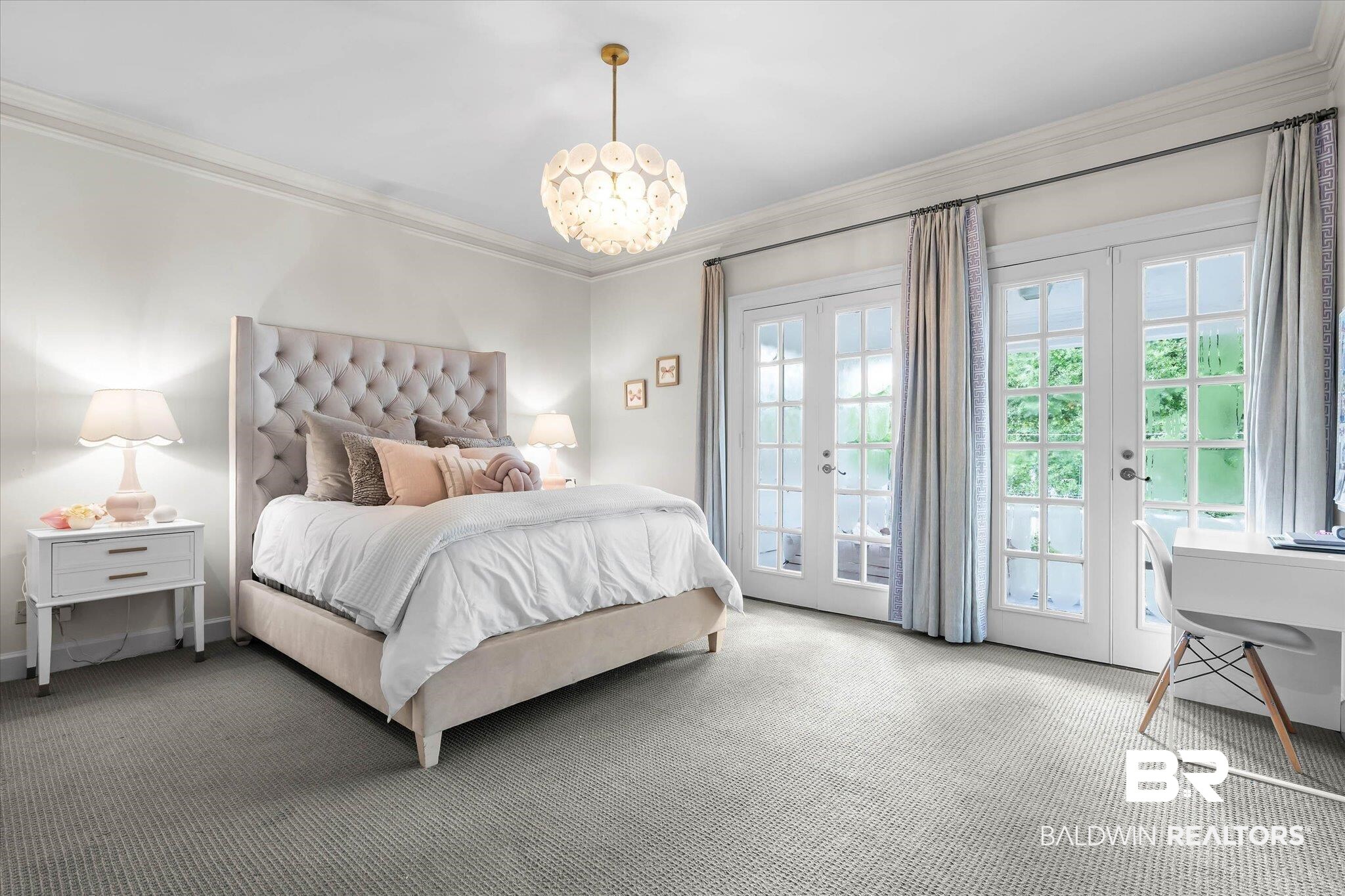 3908 Yester Place Mobile, AL 36608 - Photo 26 of 45 Spacious room featuring a tufted headboard, patterned wall-to-wall carpeting, and a decorative ceiling fixture