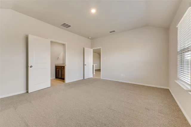 a bathroom with a granite countertop sink two mirror and shower