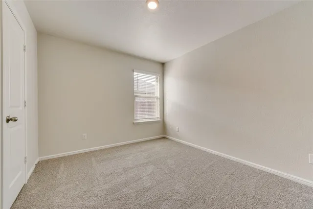 a bathroom with a granite countertop sink and a toilet