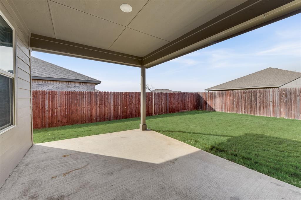 711 Durango Lane Cleburne, TX 76033 - Photo 22 of 26 a view of a backyard with wooden fence