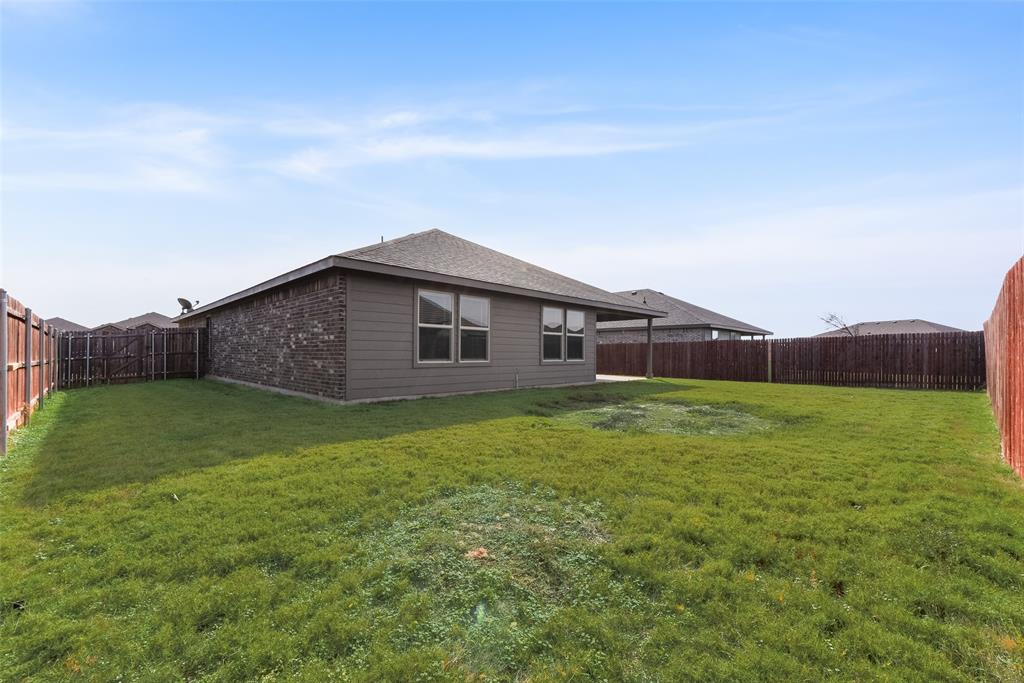 711 Durango Lane Cleburne, TX 76033 - Photo 25 of 26 a backyard of a house with lots of green space