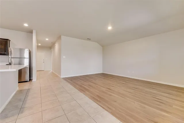 a view of a kitchen with a sink and a refrigerator
