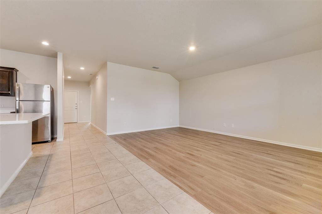 711 Durango Lane Cleburne, TX 76033 - Photo 5 of 26 a view of a kitchen with a sink and a refrigerator