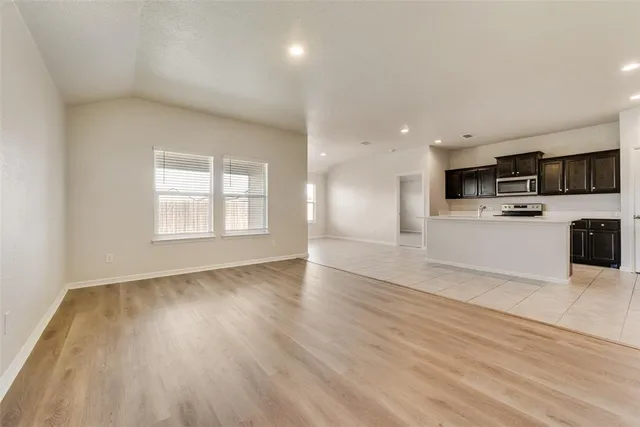 a view of kitchen with stainless steel appliances a refrigerator sink and microwave