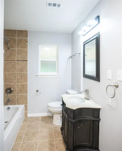 a bathroom with a sink toilet a mirror and bathtub