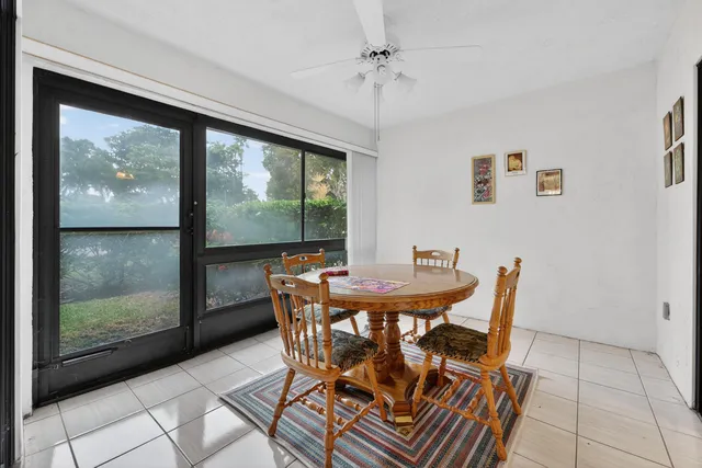 a view of a dining room with furniture large windows and wooden floor