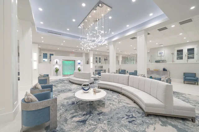 a living room with furniture and a chandelier