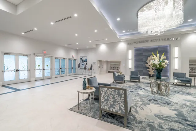 a lobby with furniture and a potted plant