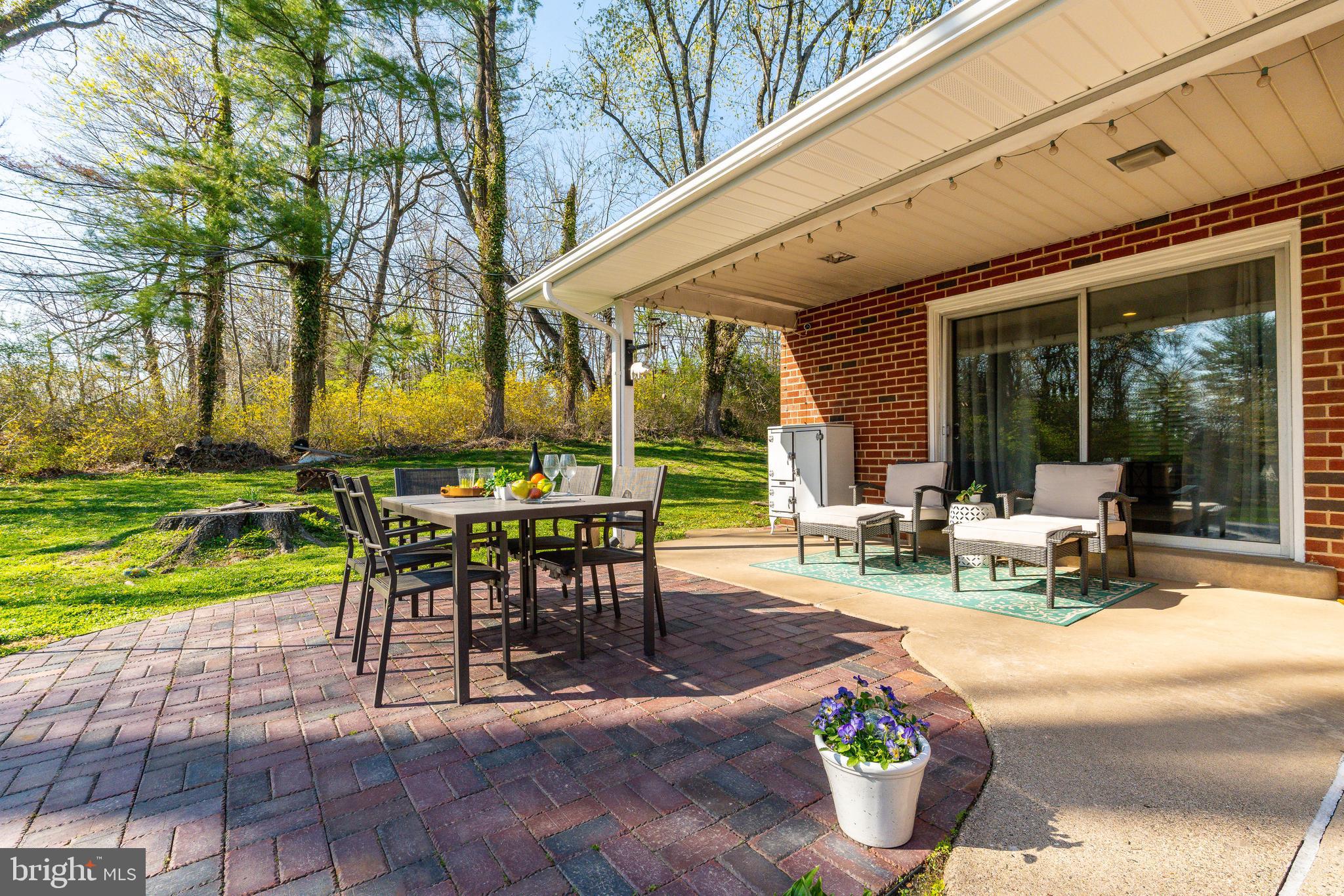 709 Alene Road Ambler, PA 19002 - Photo 29 of 42 a view of a patio with table and chairs potted plants and large tree