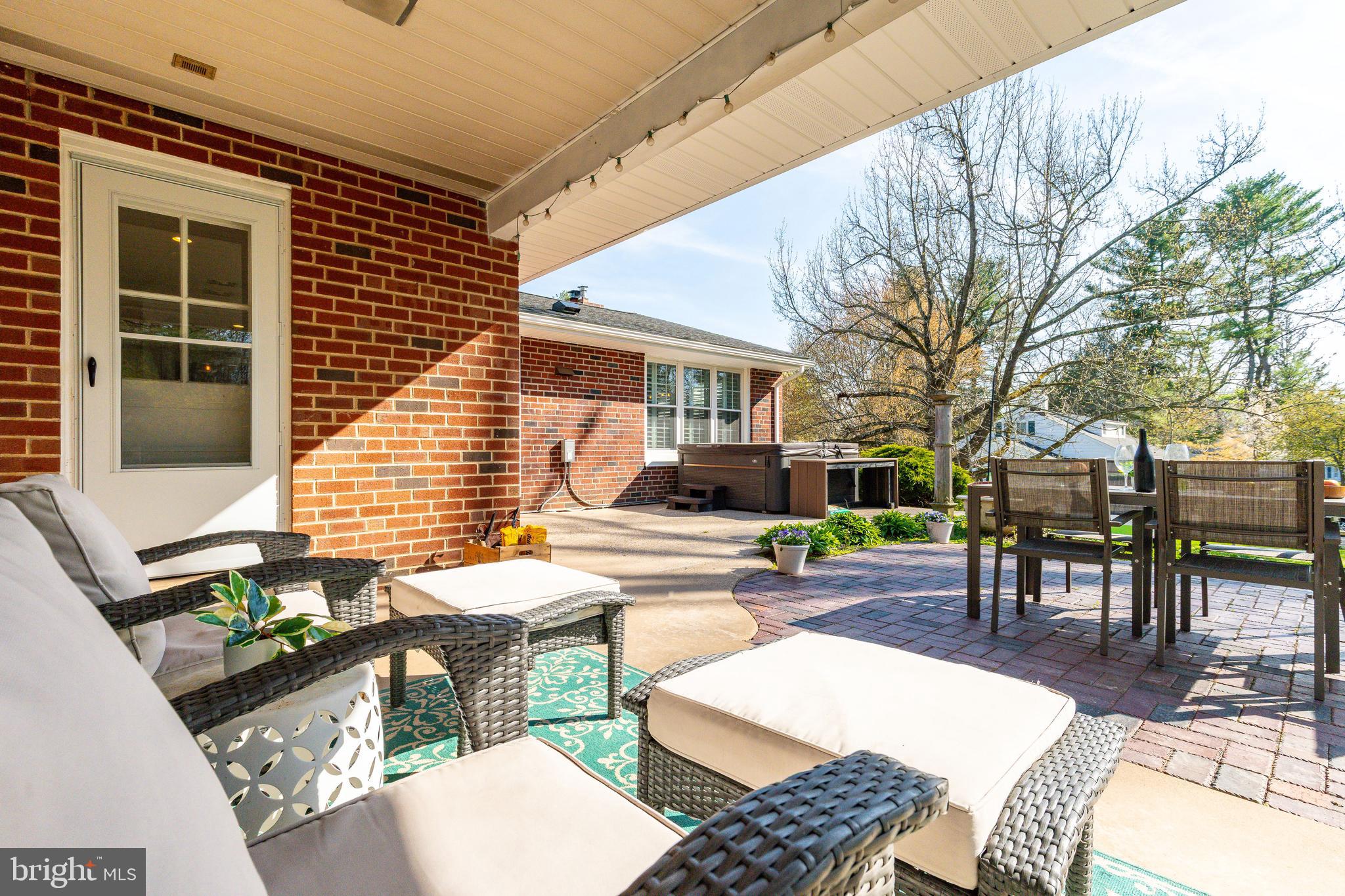 709 Alene Road Ambler, PA 19002 - Photo 30 of 42 a view of a patio with a dining table and chairs with wooden fence