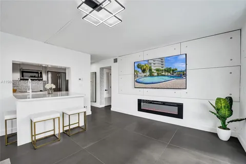 a living room with furniture potted plant and a flat screen tv