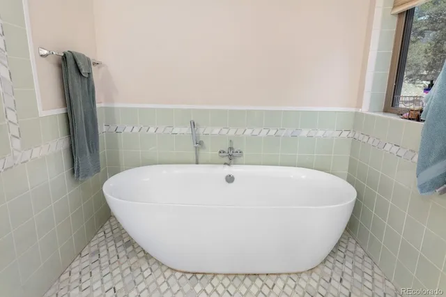 a white bath tub sitting in a bathroom