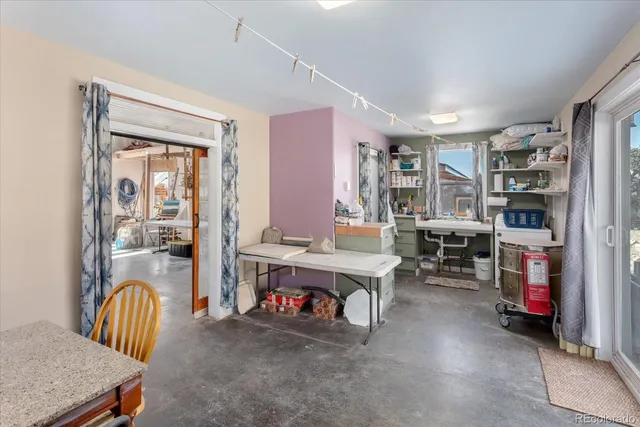 a view of a livingroom with workspace and a window