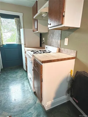 a kitchen with a stove and a refrigerator