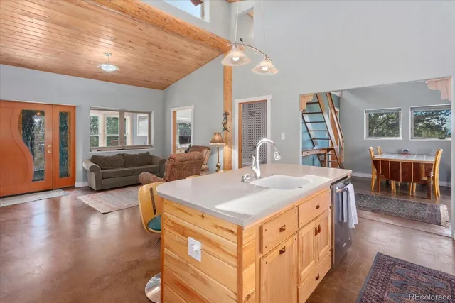 a living room with furniture a dining table and wooden floor
