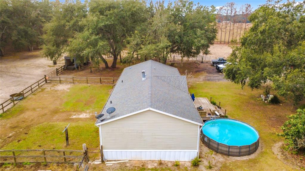 3230 Empire Church Road Groveland, FL 34736 - Photo 26 of 29 a view of a swimming pool with a yard and large trees