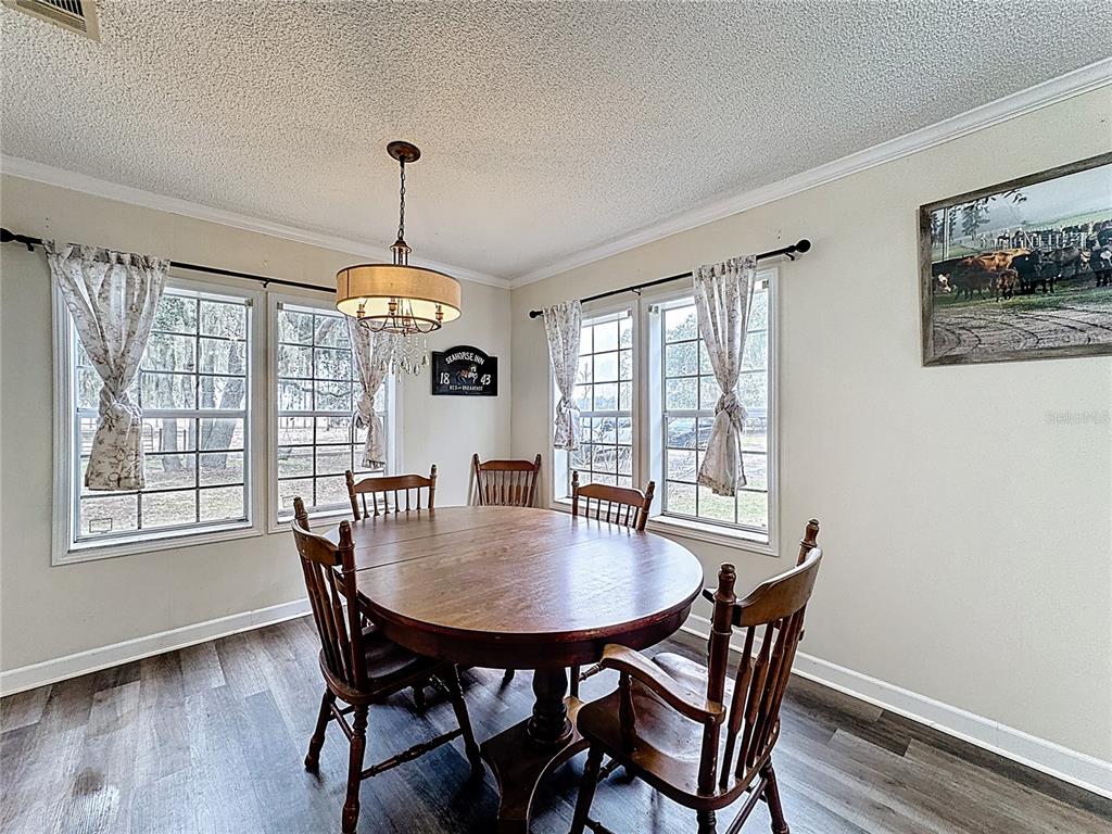 3230 Empire Church Road Groveland, FL 34736 - Photo 6 of 29 a view of a dining room with furniture window and wooden floor