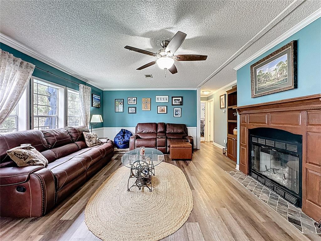 3230 Empire Church Road Groveland, FL 34736 - Photo 8 of 29 a living room with furniture and a fireplace