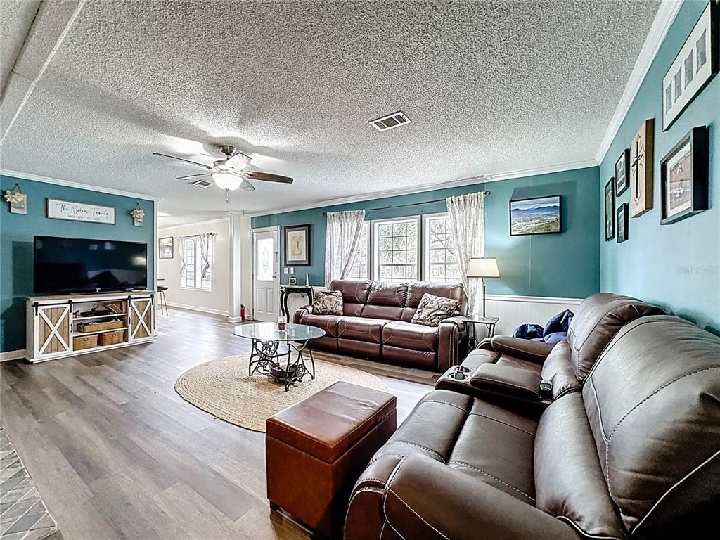 3230 Empire Church Road Groveland, FL 34736 - Photo 9 of 29 a living room with furniture and a flat screen tv