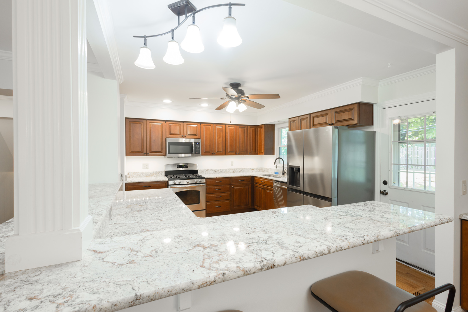 N244 Peter Road Winfield, IL 60190 - Photo 6 of 20 a large kitchen with kitchen island a sink stainless steel appliances and cabinets