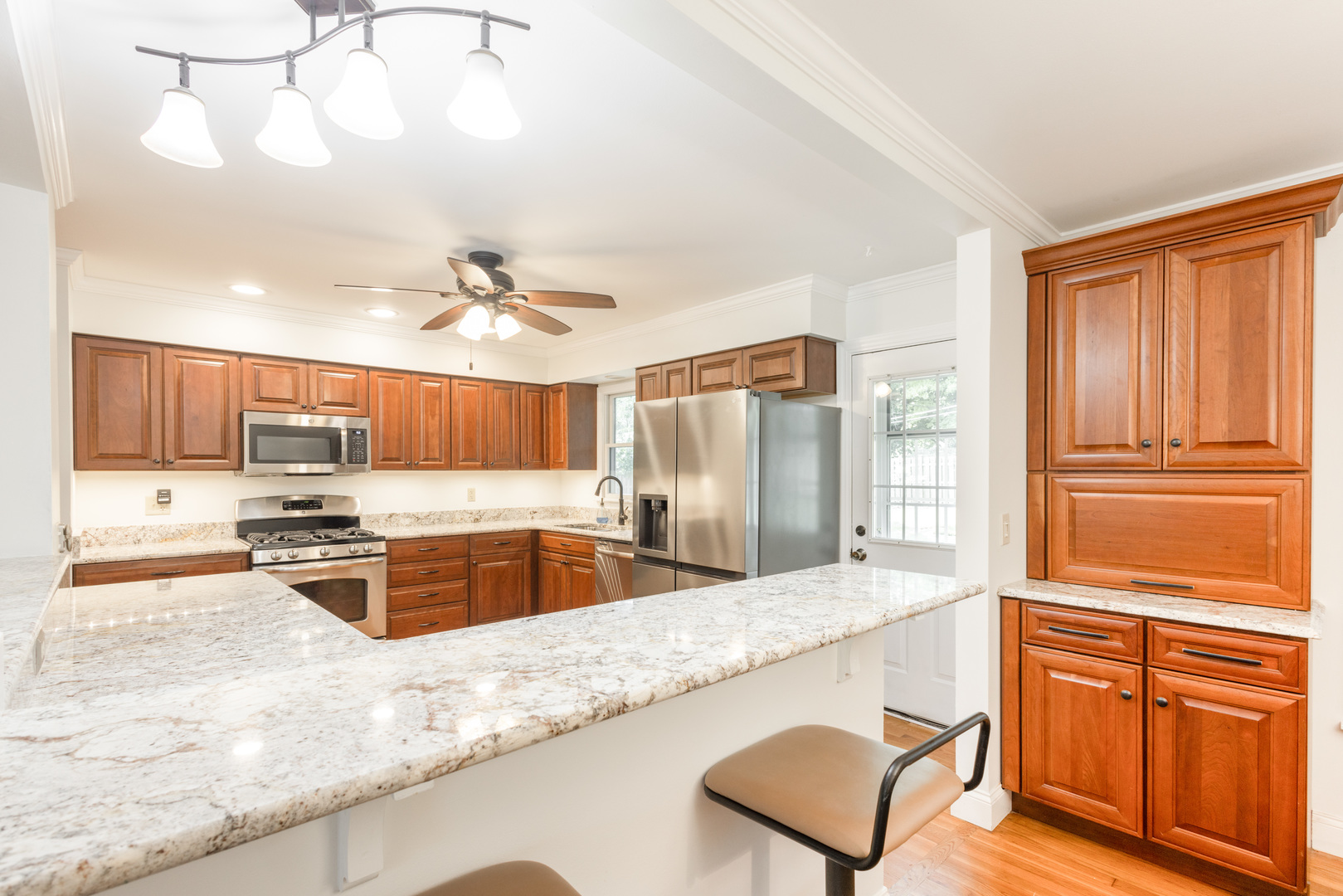 N244 Peter Road Winfield, IL 60190 - Photo 7 of 20 a kitchen with stainless steel appliances granite countertop a sink stove and refrigerator