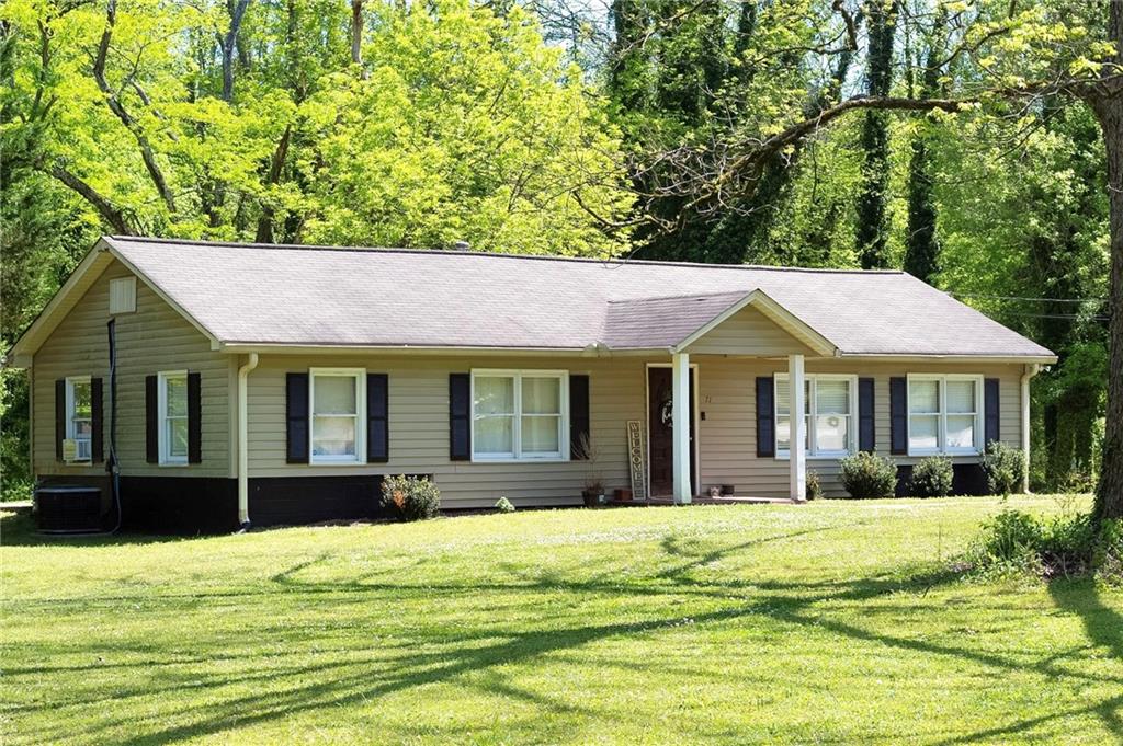71 Hughes Dairy Road Lindale, GA 30147 - Photo 2 of 18 a view of a white house with a swimming pool