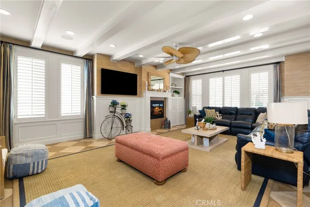 a living room with fireplace furniture and a flat screen tv