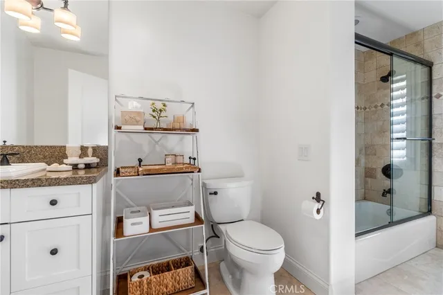 a bathroom with a toilet a sink and shower