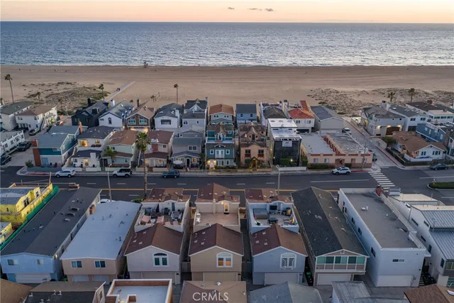 a view of city and ocean with beach