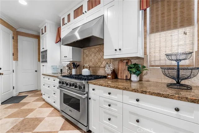 a kitchen with granite countertop white cabinets stainless steel appliances and sink