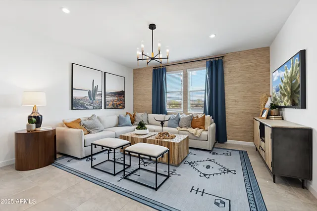 a living room with furniture a flat screen tv and a window