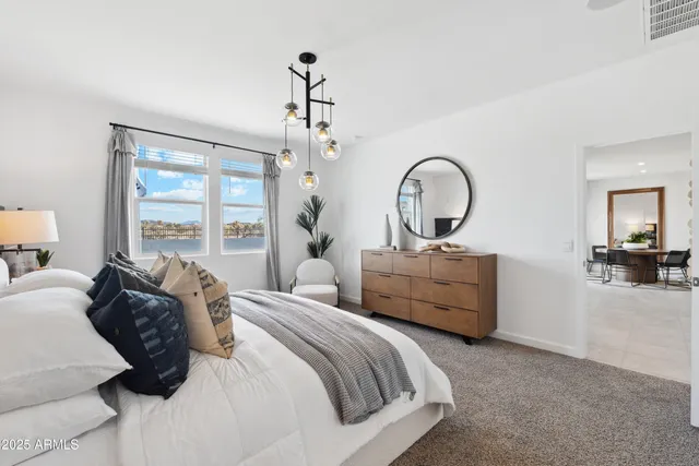 a bedroom with bed and a large window