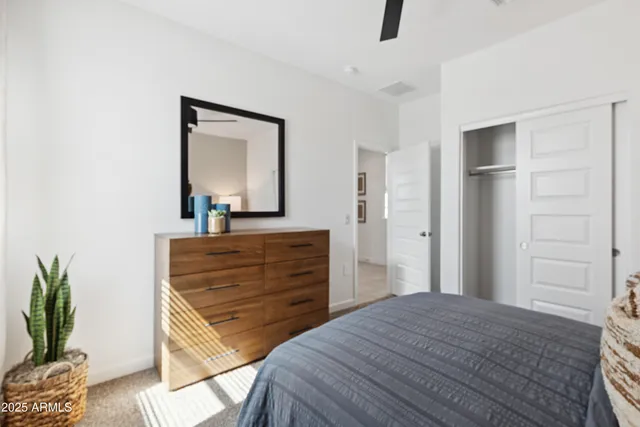 a bedroom with a bed and a mirror