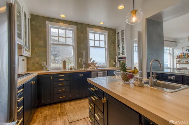 a kitchen with a sink and large window