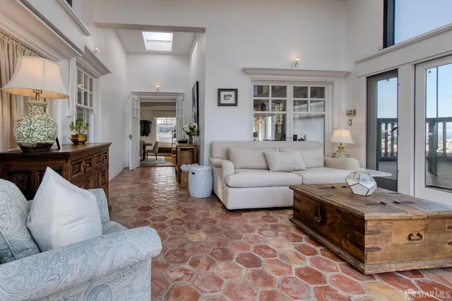 a living room with furniture and view of kitchen