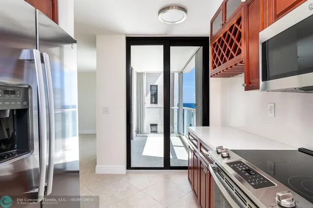 a kitchen with stainless steel appliances granite countertop a refrigerator and a stove