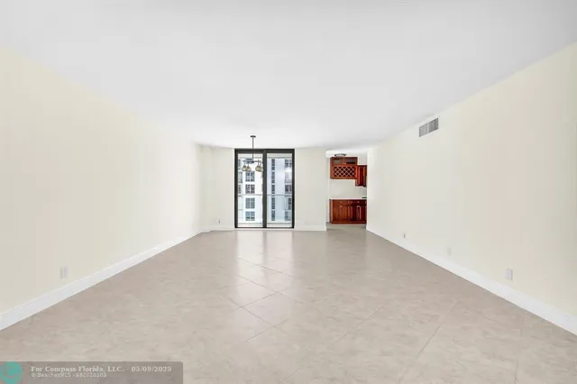 an empty room with a window and fireplace