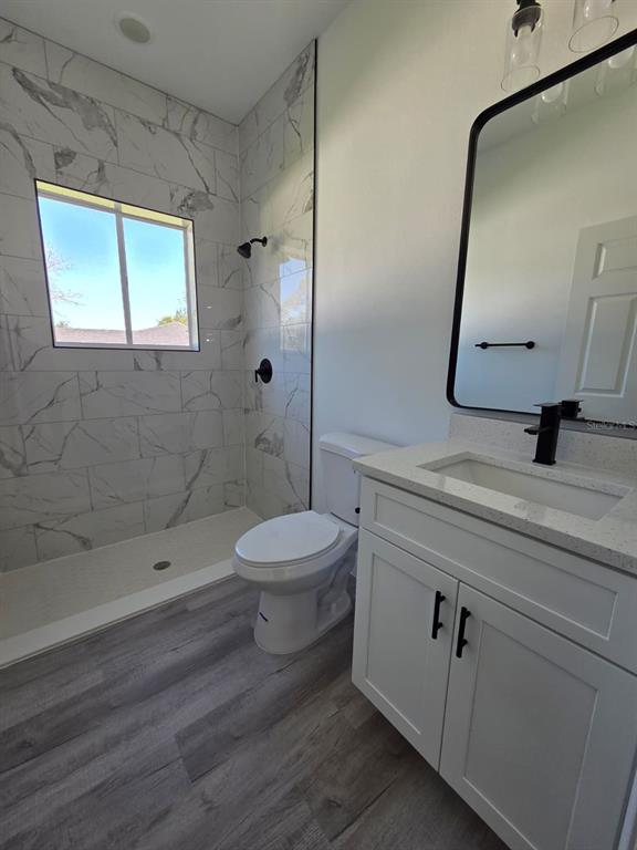 4863 Southwest 159th Lane Ocala, FL 34473 - Photo 13 of 16 a bathroom with a toilet a sink and mirror